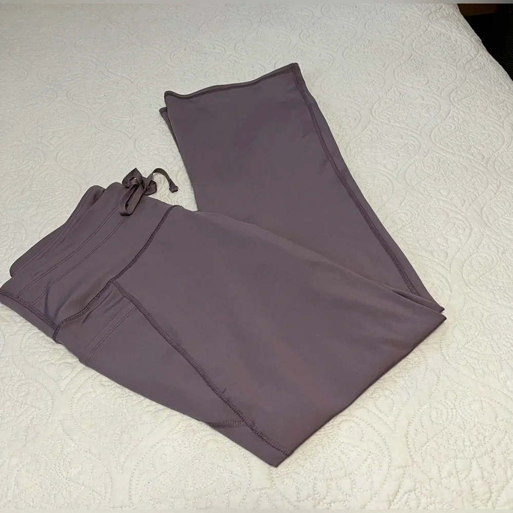NYC “Like New” worn once, ladies size XL boot leg leggings in plum/silver color.